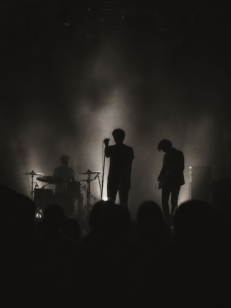 Silhouette of a band on stage, teaser for an upcoming September live music night at Cabaret Voltaire Lounge